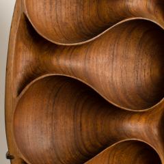 A carved wood almond shaped sculpture and base - 2033643