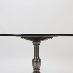 A heavy cast iron table with round glass top - 2589218