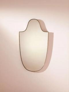 A mid century brass mirror with a shield shaped frame Italy 1950s  - 3946917