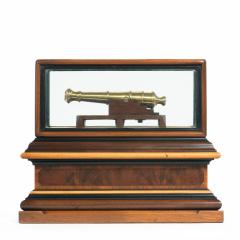 A miniature brass cannon in a presentation case - 1661535