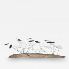 A wood and metal sculpture of a shoal of fish amongst lily pads by Martin Scorey - 3923127