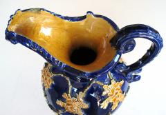 An exuberant pair of Italian cobalt glazed majolica ewers with raised decoration - 975731