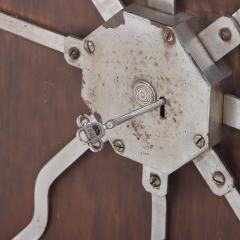 Antique steel lock mechanism mounted on a wooden board  - 4293233