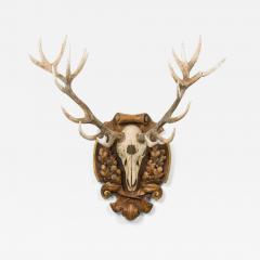 Continental Rustic Wall Plaque Featuring an Elk Skull with a Painted Insignia - 4690025