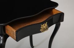 Dramatic ebonized side table with bat drawer pull - 1357621