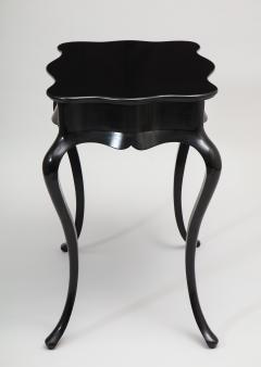 Dramatic ebonized side table with bat drawer pull - 1357625