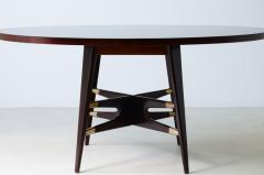Gianni Vigorelli Elegant oval table in stained wood with four legged uprights and important cross - 3226190