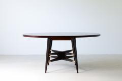 Gianni Vigorelli Elegant oval table in stained wood with four legged uprights and important cross - 3226191