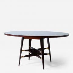Gianni Vigorelli Elegant oval table in stained wood with four legged uprights and important cross - 3229623