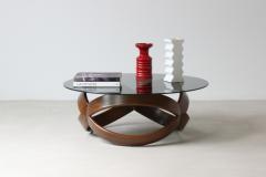 Low table with curved wooden base and smoked glass top  - 3074409