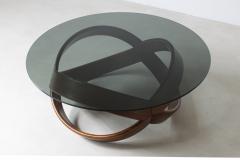 Low table with curved wooden base and smoked glass top  - 3074416