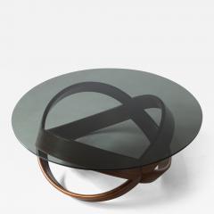 Low table with curved wooden base and smoked glass top  - 3075627