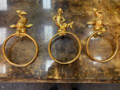 MID CENTURY TRIO OF GOLD PLATED BRASS DOLPHINS AND MERMAID TOWEL RINGS - 2539192