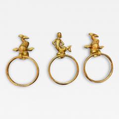 MID CENTURY TRIO OF GOLD PLATED BRASS DOLPHINS AND MERMAID TOWEL RINGS - 2545986