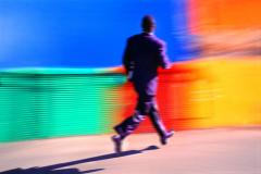 Mitchell Funk Black Businessman Running Against a Colorful Background - 3168999