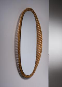 Oval wall mirror with a wooden and rattan frame - 2826731