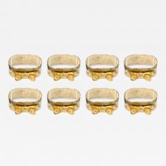 SET OF EIGHT SIVERPLATE GOLDTONE BOW DESIGN NAPKIN RINGS - 4560032