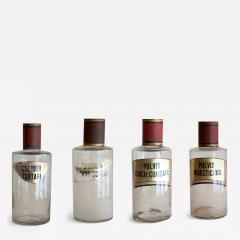 SET OF FOUR HAND BLOWN GLASS APOTHECARY BOTTLES WITH GILT AND RED TOPS - 3679441