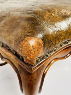 The leather shows wear and signs of repair  - 3235779