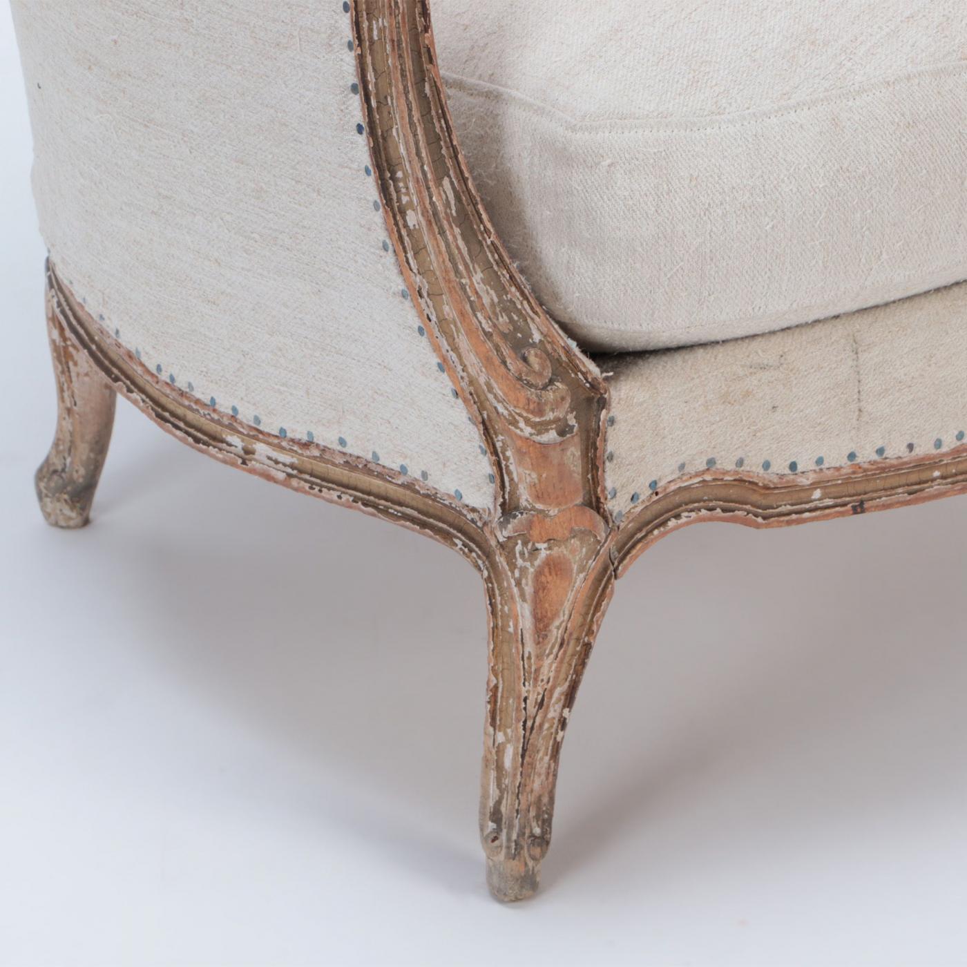 A French Louis XV style armchair and ottoman. Circa 1910.