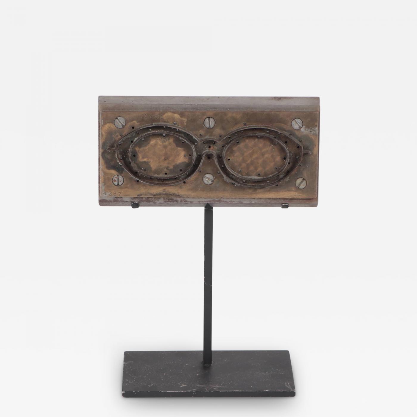 A Mid Century Modern French steel and brass eyeglasses mold circa 1950.